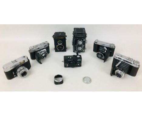 A collection of Rolleiflex and Voigtlander cameras, comprising a Rolleiflex DPM DPGM Synchro Compur camera, serial number 126