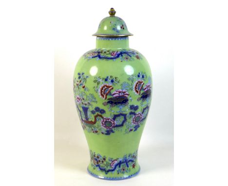 A Chinese style ceramic vase and cover, early 20th century, printed and underglaze decoration with bands of flowers against a