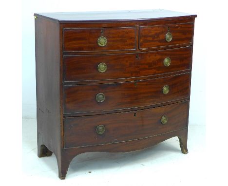A Regency mahogany bowfronted chest of two short over three long graduating drawers, turned handles, raised on bracket feet, 