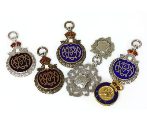 A collection of silver badges, to include two silver and enamel Angling Team examples