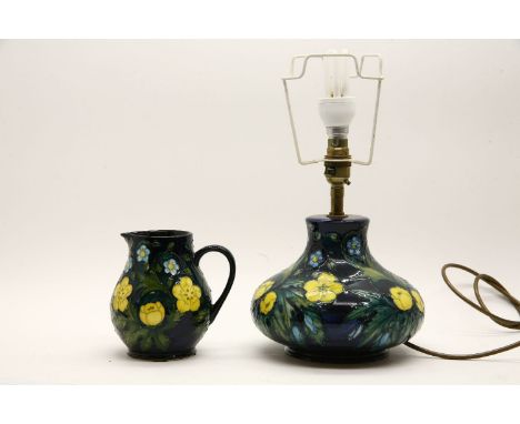 A Moorcroft 'Buttercup' jug 15cm, together with a Moorcroft Buttercup table lamp, 37cm (2)