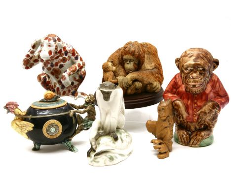 An Oriental soapstone group, depicting monkeys beside a vase, 21cm wide x 16cm high, together with an Imari model of a monkey