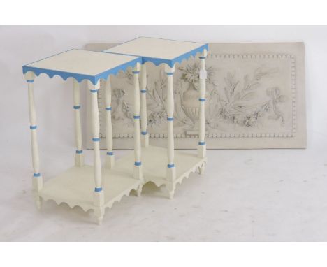 A pair of painted lamp tables, white with blue highlights, two tiers with scalloped aprons and turned supports, together with