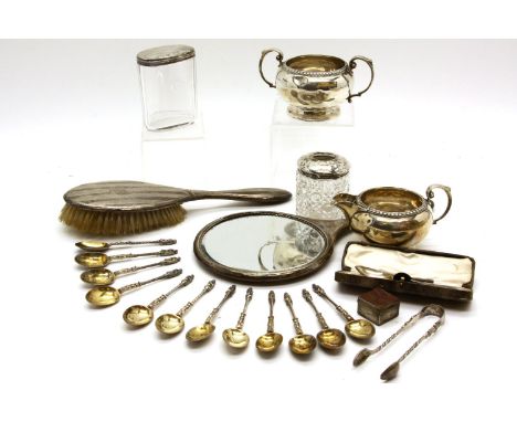 A set of twelve silver apostle spoons with silver gilt bowls, together with a silver cream jug and sucrier, a silver backed d