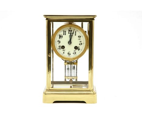 A 19th century brass four glass mantel clock, with white enamel dial and gong strike movement, 22.5cm high