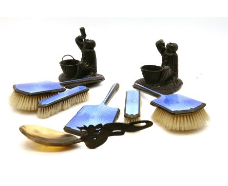 A silver and blue enamel five piece dressing table set, Chester 1939, together with a carved horn spoon and a pair of figural