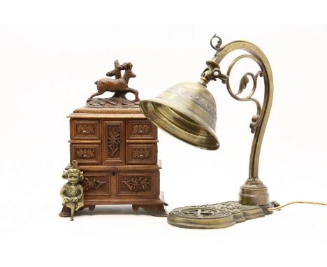 A black forest carved walnut spice cabinet, with stag surmount, 30cm high, together with a brass student's lamp and a monkey 