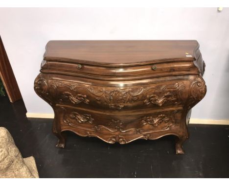 A Continental style walnut bombe commode chest, with carved drawers, 130cm wide