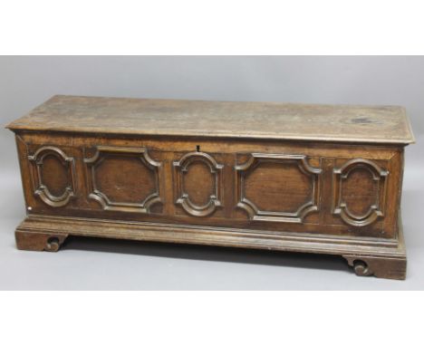 ITALIAN WALNUT CASSONNE, late 17th century, the hinged cover above a five panelled front with moulded frames on scrolling bra