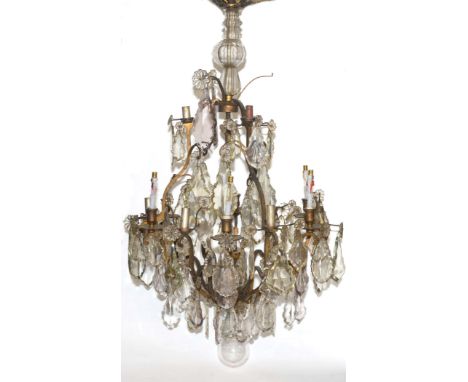 LARGE FRENCH TWENTY LIGHT BRASS AND CUT GLASS CHANDELIER, the two tiers of scrolling branches with glass flowerheads and cut 