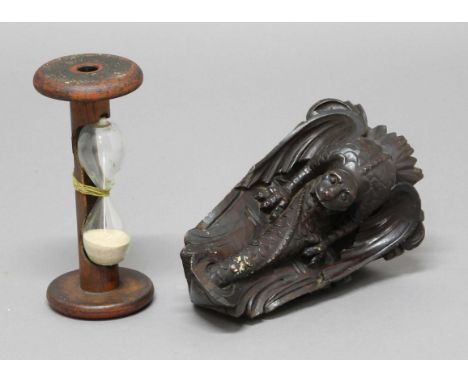 PINE CORNER WALL BRACKET, carved as a scaly, winged dragon, dark stained, height 27cm; together with a sand timer formed from