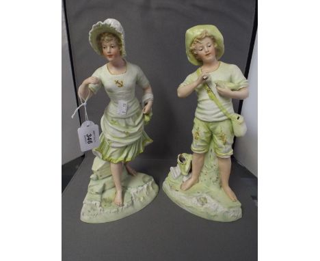 A Pair of Continental Bisque Ornaments of A Boy and Girl 
