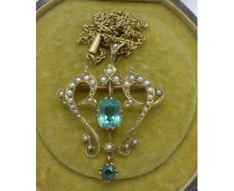 A 9ct gold pendant or brooch set with seed pearl and blue stones on a 9ct gold chain