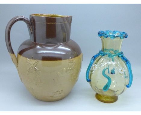 A Doulton Lambeth relief moulded jug with hunting and drinking scenes, and a continental glass vase enamel decorated with fis