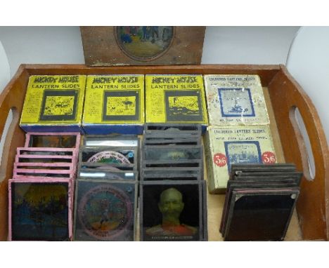 A collection of lantern slides including three sets of Mickey Mouse slides and views of London, etc.