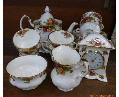 A Royal Albert Old Country Roses six setting tea service, six cups, saucers, side plates, sugar, cream, teapot and a clock