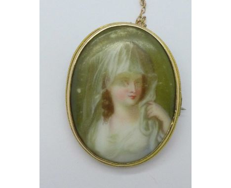 A portrait miniature set in a yellow metal brooch mount