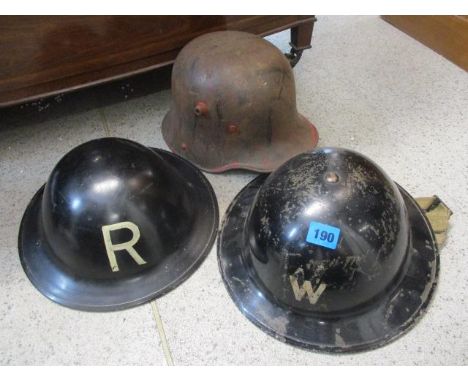 Two WW2 Warden helmets and a German WW1 helmet 