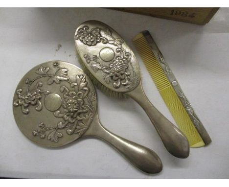 An oriental silver dressing table mirror and brush with comb 