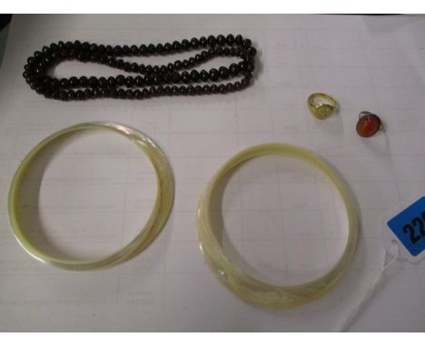 An 18ct gold signet ring, two mother of pearl bangles, a gold and silver coloured ring and an amethyst coloured bead necklace