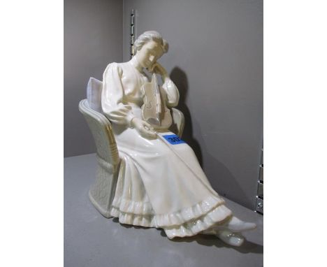 A modern Bing and Grondahl figure of a seated lady playing her violin, 8 1/2"h 