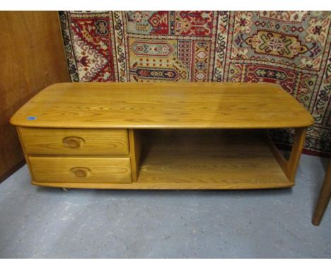 An Ercol light elm coffee table with two short drawers and an open shelf, on castors, 16"h x 49"w 