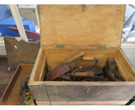 Old wood working tools containing in a pine chest and a Victorian cast iron fire hood 
