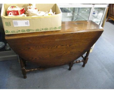 An oak gateleg dining table, 47 3/4" h x 13 7/8"w x 29 3/4"w, unextended and four Ercol spindle back chairs 