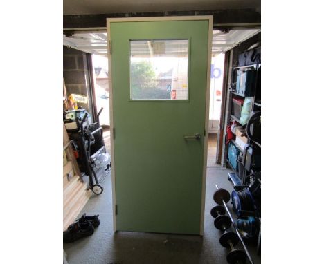 Fire door with glazed panel hung in frame with catch fitted, intumescent strips supplied along with handle. Frame size H2005m