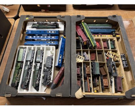 Two trays of model train engines and rolling stock