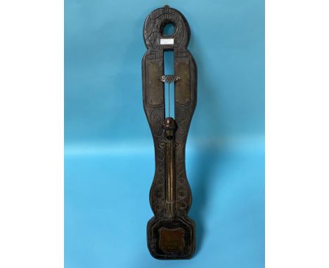 A carved oak water clock