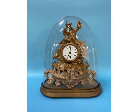 A gilt metal clock under a glass dome