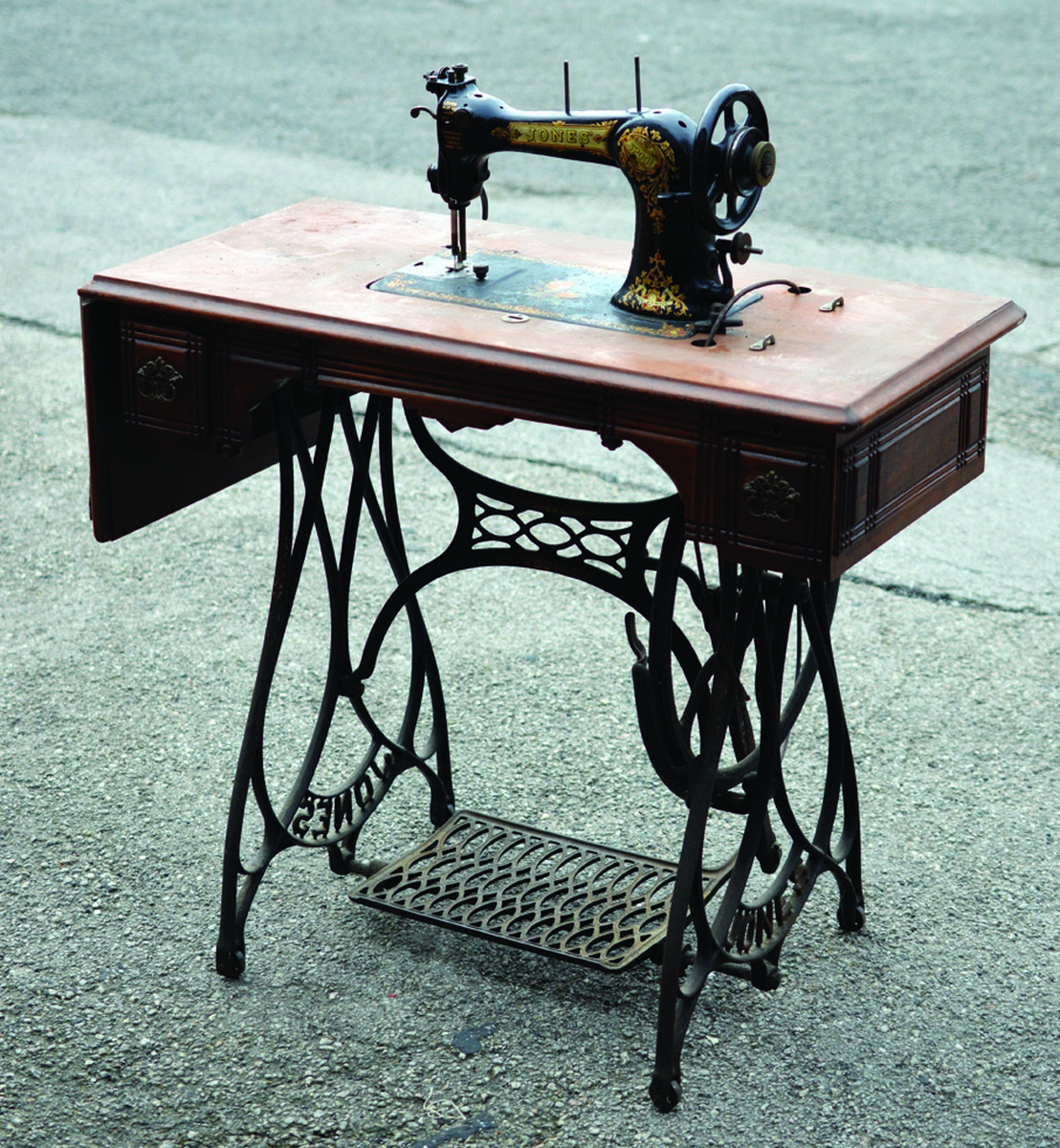 JONES SEWING MACHINE. 40ins tall to top of wooden cover. Table machine with cast base, treadle op
