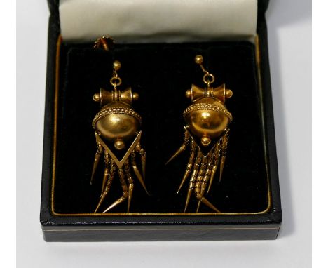 A pair of Victorian hollow gold drop earrings, the stylised bow surmounting a sphere with beaded band around the circumferenc