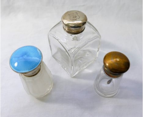 A small panel cut glass bottle with silver and guilloche enamel screw lid, 8.5cm high, a square section glass bottle with sil