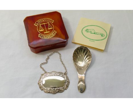 An Edwardian silver caddy spoon with shell bowl, Chester 1905, 8.5cm long, and a modern silver decanter label, Birmingham 199