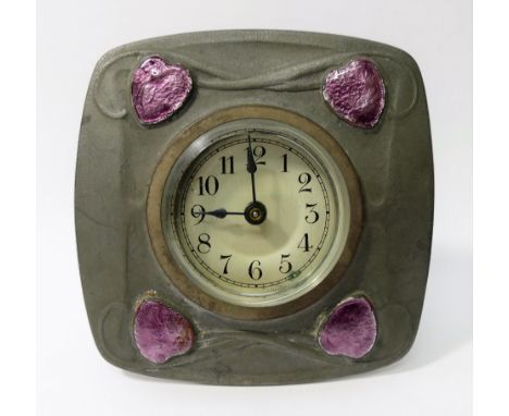 An Archibald Knox (1864 - 1933) Liberty and Co. pewter and enamel cased easel backed clock, the back stamped 'English Pewter 