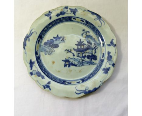 A Nankin Cargo Chinese porcelain blue and white plate, with wavy rim, the centre decorated with pagodas amongst trees, origin