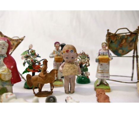 A miniature 19th century German Hertwig bisque doll, with jointed arms and flowers in her hair, 5.5cm high, a bisque figure o