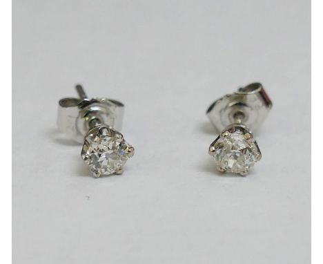 A pair of diamond stud earrings, the round old-cut stones approximately 0.40 carats each, in white six-claw setting, with but