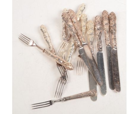 A set of six Victorian dessert knives and forks with ornate filled handles and one other fork with filled silver handle.