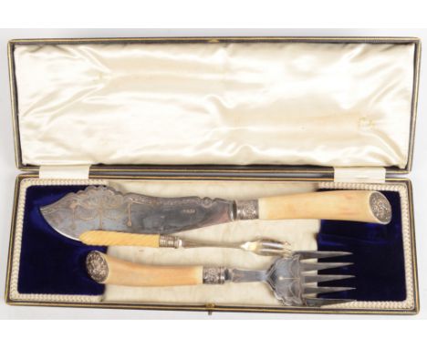 A pair of ornate fish knives and forks cased and a pickle fork.
