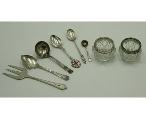 An Art Nouveau bull-nosed silver serving fork, various silver spoons, 4.1oz, together with a pair of glass silver mounted sal