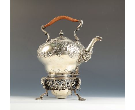 An ornate rococo silver spirit kettle with floral and acanthus repousse decoration, the spout in the form of a bird's head, o