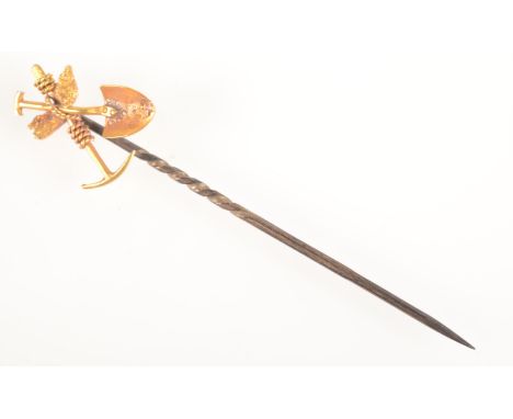 A miner's stickpin the gold finial with crossed spade and pick tied about a nugget.
