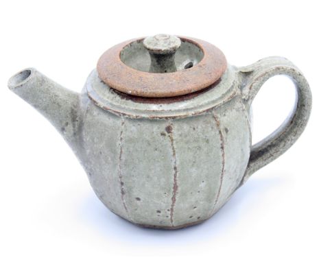 A small stoneware cut sided teapot.From the Bret Guthrie CollectionOriginally born in Barrow-in-Furness in 1916, to a Russian