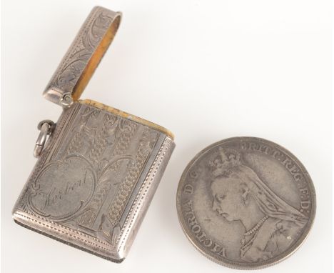 An engine turned and engraved silver vesta case, together with a Victorian silver crown 1888.