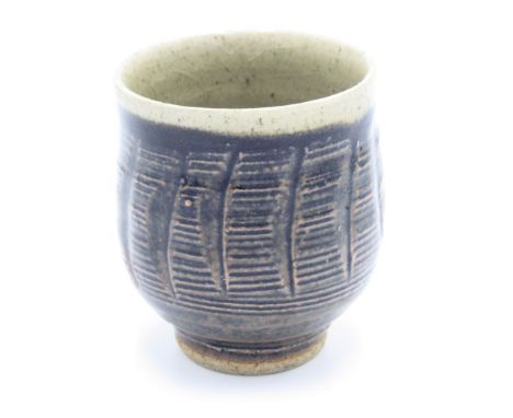 A Leach Pottery stoneware tenmoku glazed and carved tea bowl, St Ives mark, height 8.8cm, diameter 7.7cm.From the Bret Guthri