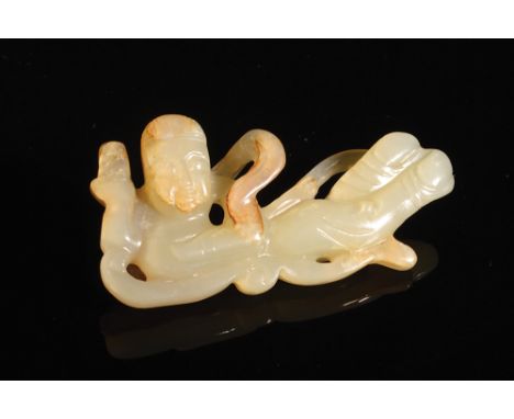 A Chinese pierced and carved mutton fat /white jade pebble, carved as a Buddhist angel 'T'ien-jen', shown in long flowing rob