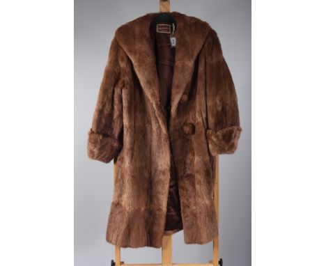 A lady's fur coat, label inscribed 'The Arctic Fur Stores, Crouch End'. light brown fur with dark brown satin lining, length 